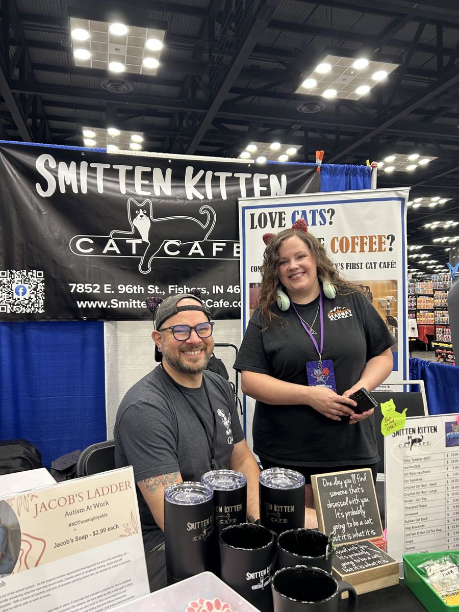 Smiling Smitten Kitten Cat Cafe team at their PurrCon booth