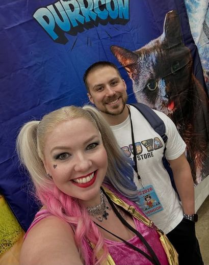 Cosplayer selfie with a friend at the PurrCon backdrop