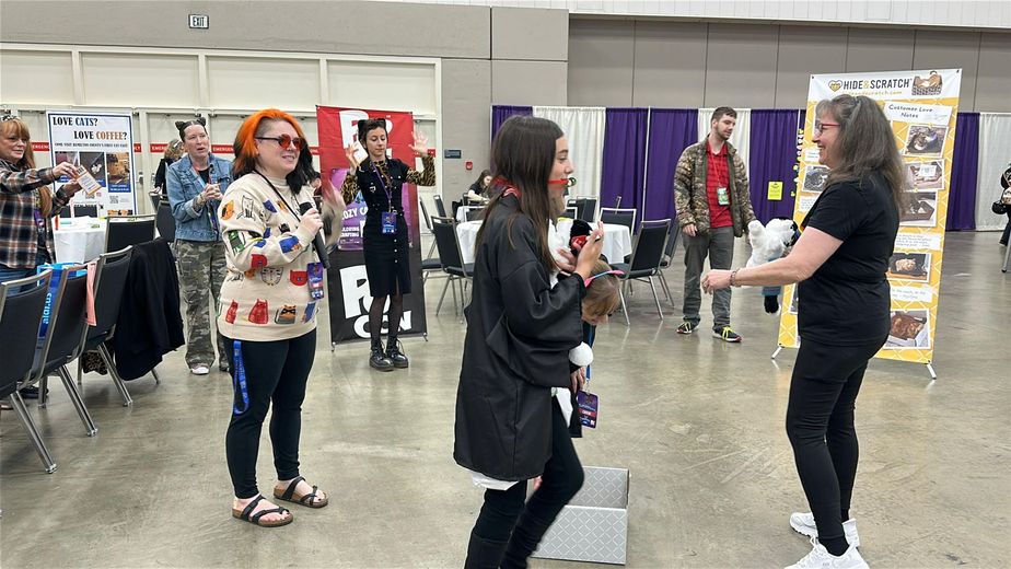 Attendees playing a game on the PurrCon convention floor