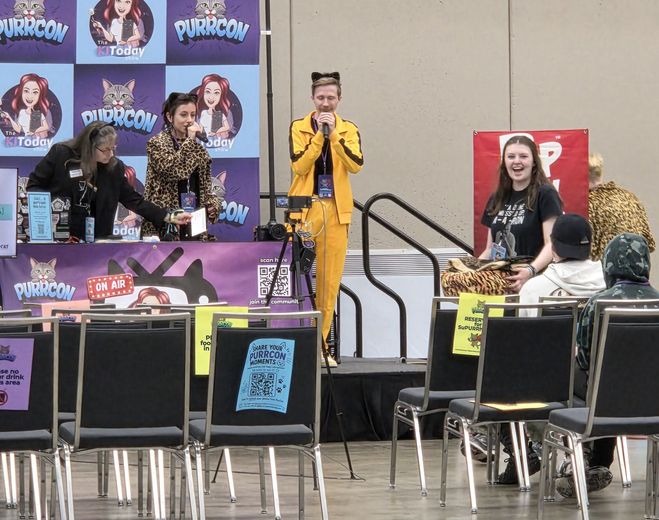 Cosplayer in a yellow tracksuit on The Cat Conversation stage