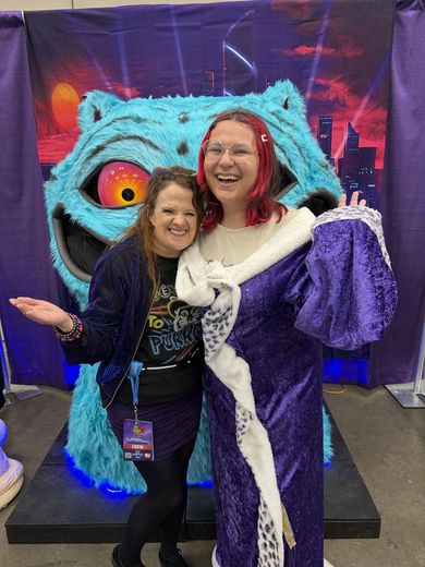 Cosplayer and friend posing with the giant blue cat photo op