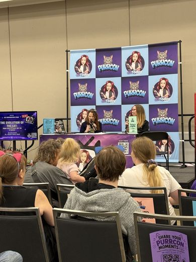 Audience watching a panel at The Cat Conversation stage
