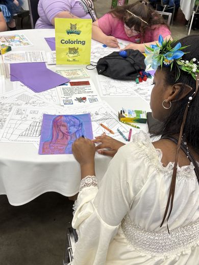 Attendee coloring at a PurrCon craft table