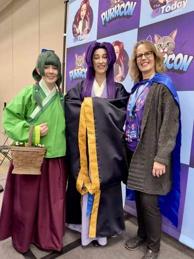 Cosplayers posing at the PurrCon backdrop