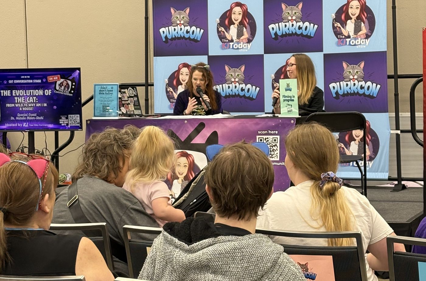 KJ recording The Cat Conversation live on the PurrCon stage in front of an audience
