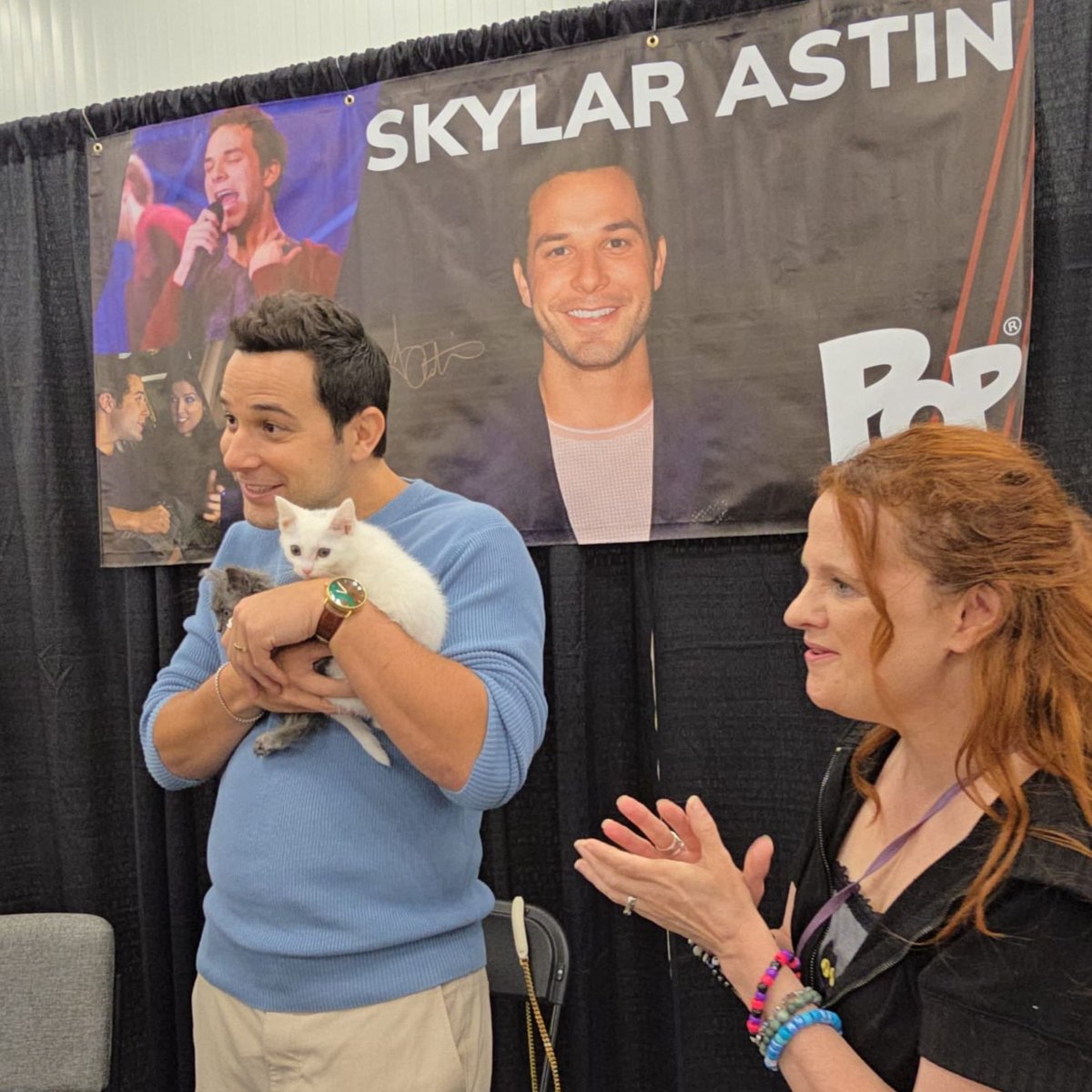 Skylar Astin holding kittens during Kitten Therapy at PurrCon 2025